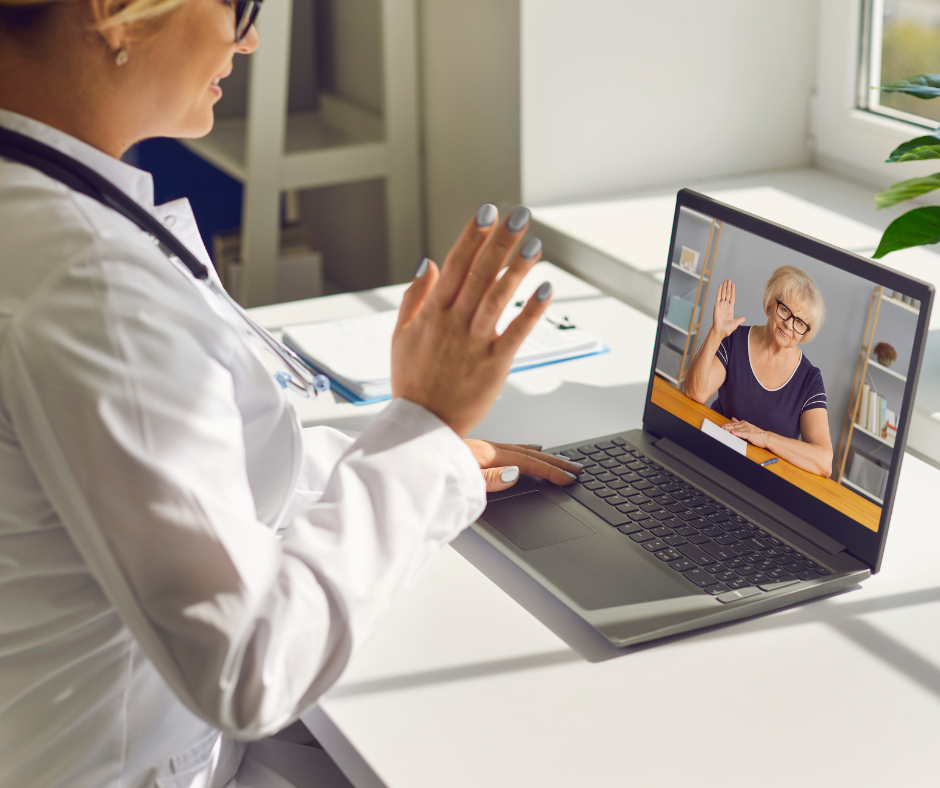 Doctor using computer to connect with client for a telehealth appointment. 